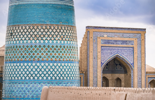 The Kalta Minar and Madrasah of Muhammad Amin Khan is lined with mosaics and ceramic tiles in the ancient city of Khiva in Khorezm, medieval architecture photo