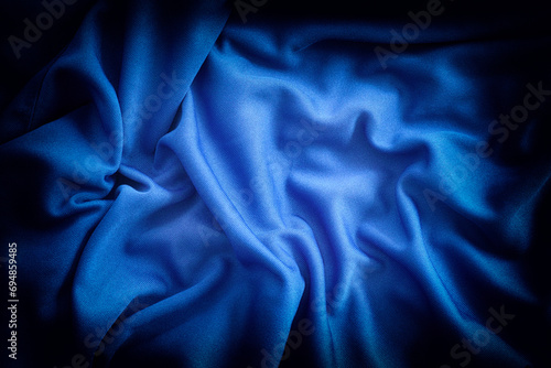 A crumpled blue fabric background. Close up.