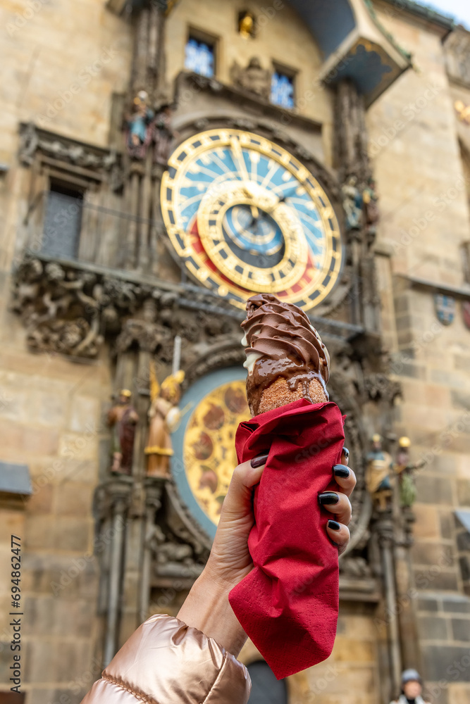 Female hand is holding traditional czech cookie trdelnik