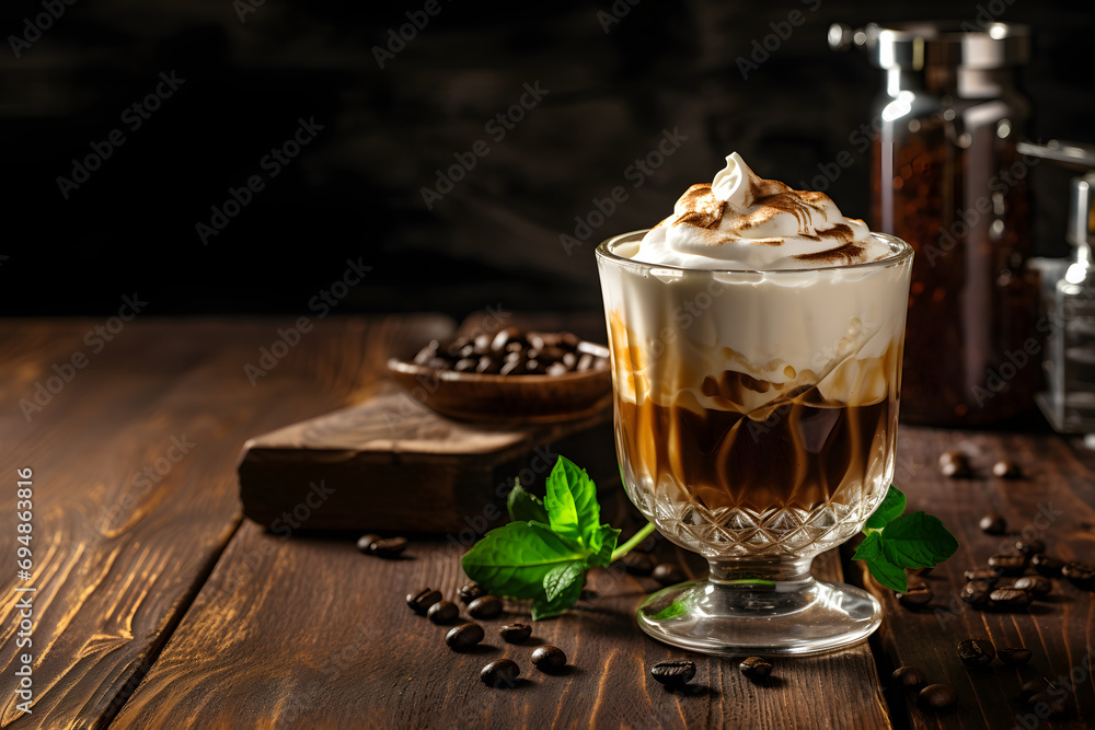Cold coffee with vanilla ice cream in a glass on a black wooden background. Irish coffee delight. Cold coffee with vanilla ice cream in a glass on a black wooden background. Irish coffee delight.