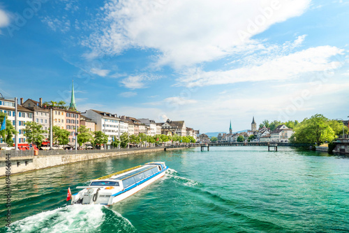 Scenic view of historic Zurich city center with famous Fraumunster and Grossmunster Churches and river Limmat at Lake Zurich on a sunny day with clouds in summer, Canton of Zurich, Switzerland photo