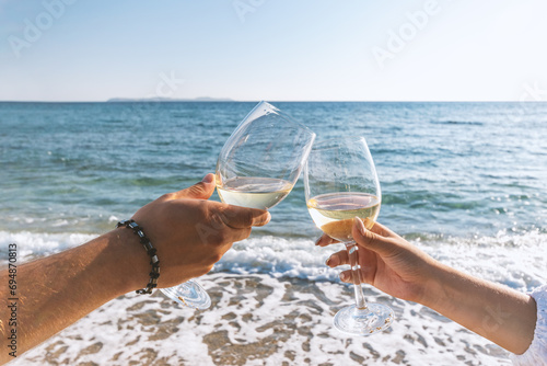 Wallpaper Mural Two hands with glasses of wine on the beach. Summer vacations concept. Torontodigital.ca