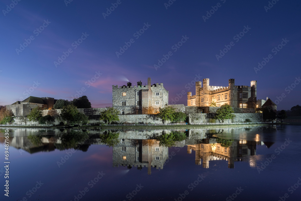 Leeds Castle at night, illuminated, reflected in moat, near Maidstone, Kent, England Leeds Castle at night, illuminated, reflected in moat, near Maidstone, Kent, England