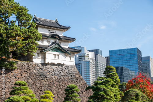 Fujimi-yagura guard tower in the Imperial Palace of Tokyo and modern skyscrapers in the background, Honshu, Japan photo