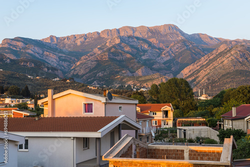 View of a small village with mountain houses on the mountain crest in Bar city Montenegro. Sunset