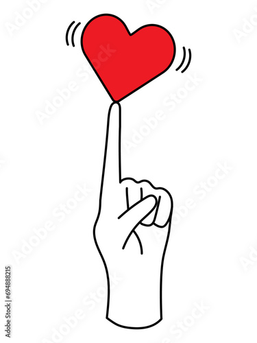 指の上で微妙なバランスをとるハート