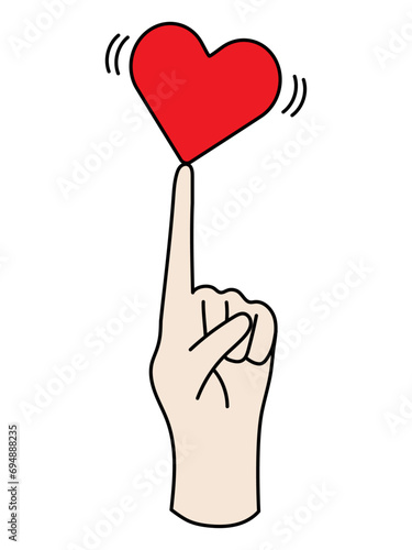 指の上で微妙なバランスをとるハート