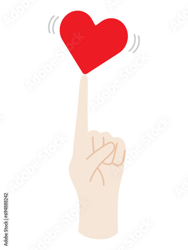 指の上で微妙なバランスをとるハート