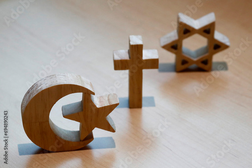 Christianity, Islam, Judaism, the three monotheistic religions in symbols of Jewish Star, Christian Cross and Islamic Crescent, France photo
