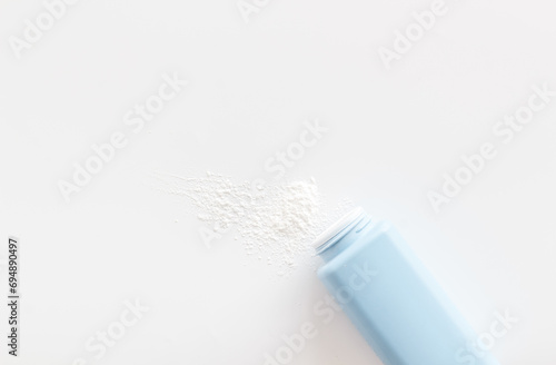 Spilled baby talcum powder. Container with powder for baby body care