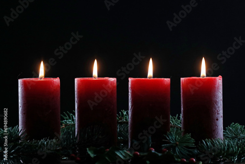 Natural Advent wreath or crown with four burning red candles, Christmas composition, France photo