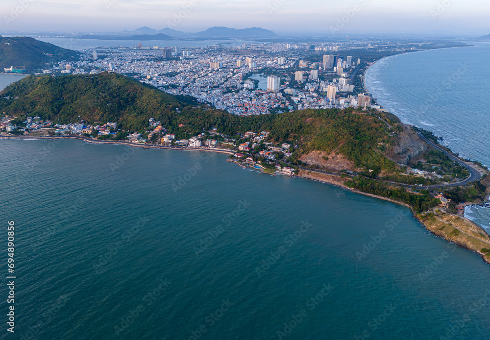 Aerial view of Vung Tau city, Vietnam, panoramic view of the peaceful and beautiful coastal city behind the statue of Christ the King standing on Mount Nho in Vung Tau city.