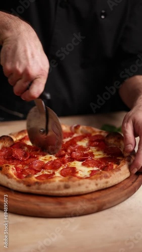 the chef cooks delicious pizza. cut the pizza into portions