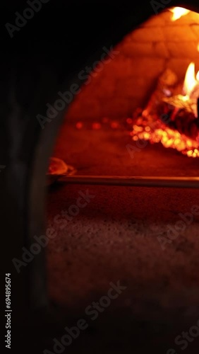 The pizza is baked in the oven. 