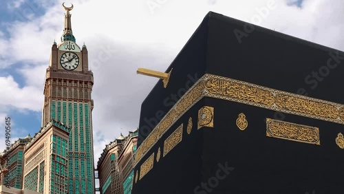 Timelapse of Holy mosque of Mecca and Makkah Clock Royal Tower. Haram Mosque minaret in a cloudy day. Mecca, Islam’s holiest city and the central Masjid al-Haram, Sacred Mosque surrounds the Kaaba.