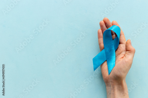 Wallpaper Mural Blue ribbon symbol of colon or prostate cancer with hands. Medical support and prevention Torontodigital.ca