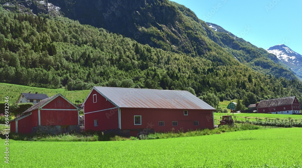 Green Farmland with red farm buildings
