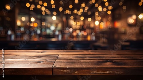 Empty wooden table in front of blurred café bar photo