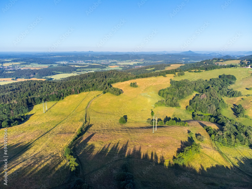 Green hilly landscape with green meadows and forests. Jested ridge near Liberec, Czechia. Aerial view from drone.