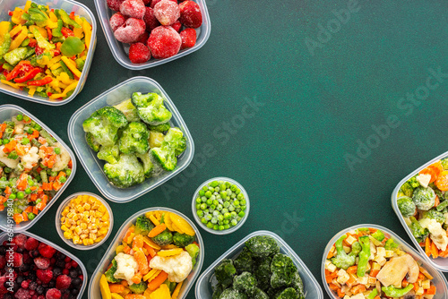 Preparing food for the winter, freezing fresh vegetables in the summer in the refrigerator, various frozen vegetables in plastic dishes on a green background