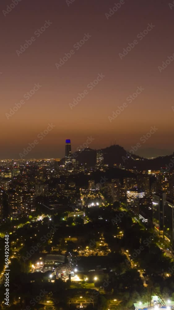 Sparkling Santiago Skyline at Night. Aerial Hyper Lapse, Time Lapse. Las Condes Commune. Chile. Drone Flies Sideways. Vertical Video Sparkling Santiago Skyline at Night. Aerial Hyper Lapse, Time Lapse. Las Condes Commune. Chile. Drone Flies Sideways. Vertical Video