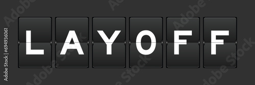 Black color analog flip board with word layoff on gray background