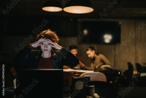 Confident businesswoman strategizing for business expansion in a creative office. Analyzing market data, targeting a specific group, ensuring profitability and revenue growth.