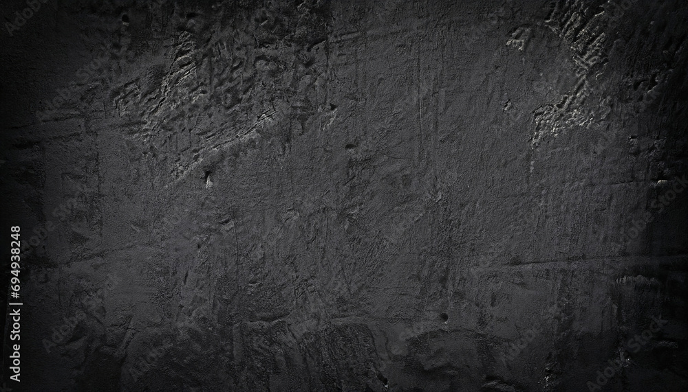 Fototapeta premium A close-up view of a dark grey, rough-textured concrete wall, black painted background wall textured