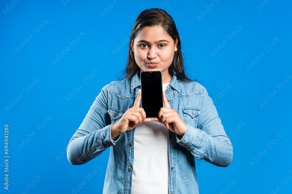 Indian women holding mobile phone with blank display Indian women holding mobile phone with blank display