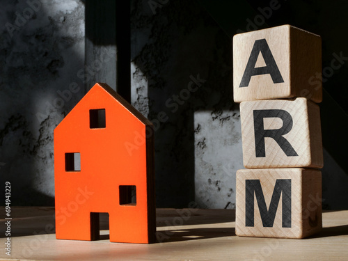 House figurine and cubes ARM adjustable rate mortgage. photo