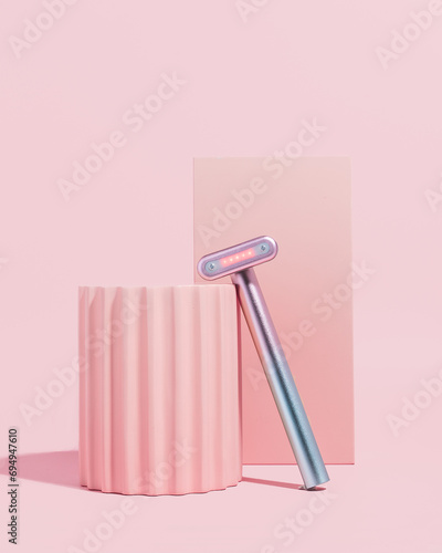 Red light therapy skincare wand on pink background