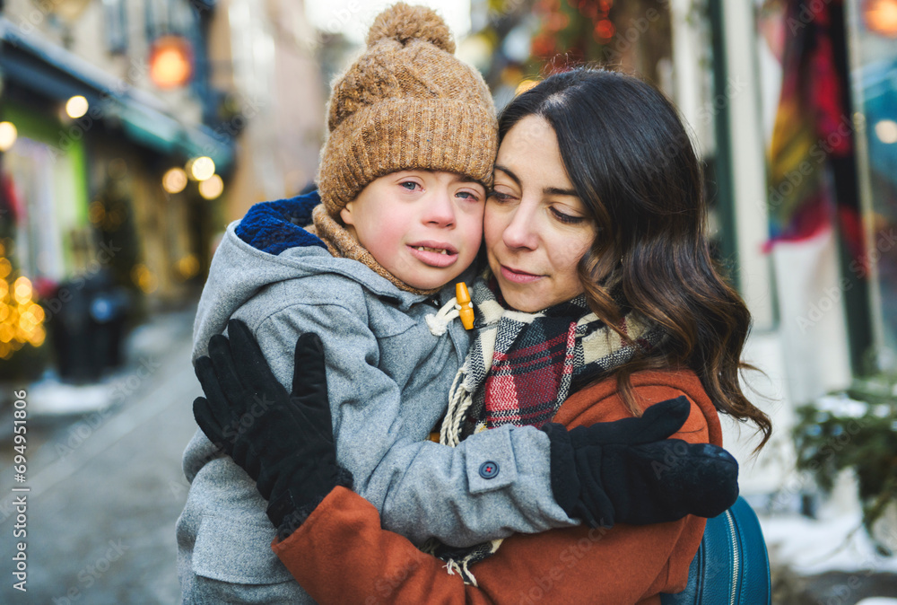 mother with little son consoling outdoor on frosty day