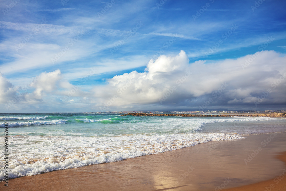 Fototapeta premium Seacoast of Costa da Caparica city. View of Lisbon fron Costa da Caparica beach. Almada, Portugal