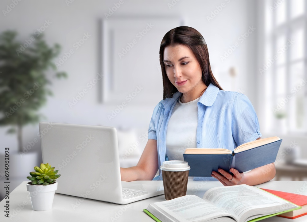 A young girl student works at laptop at home A young girl student works at laptop at home