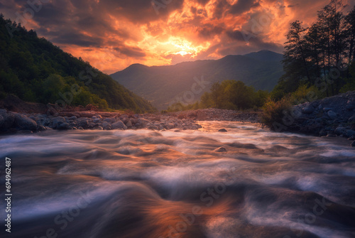 fast mountain river flowing In sunset time