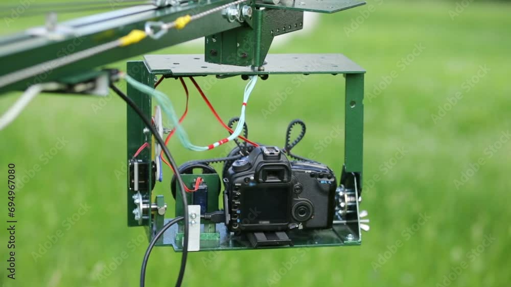 Head of homemade crane with camera moves and turns in summer Head of homemade crane with camera moves and turns in summer