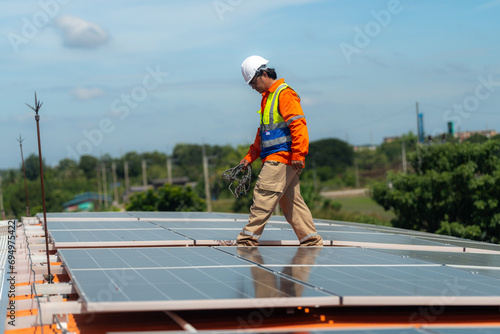 engineer men inspects construction of solar cell panel or photovoltaic cell by electronic device. Industrial Renewable energy of green power. factory worker working on tower roof.