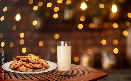 Cozy christmas glass of milk and sweet cookies on desk