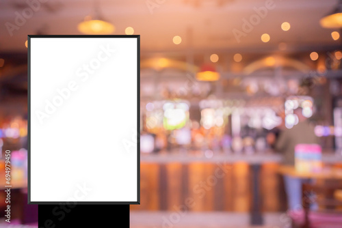 mock up blank white poster standing on blur restaurant background for show or promote promotion