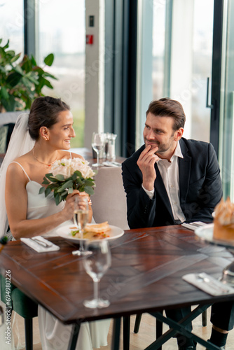 portrait of smiling bride and groom in love newlyweds at wedding in restaurant during celebration of love romance