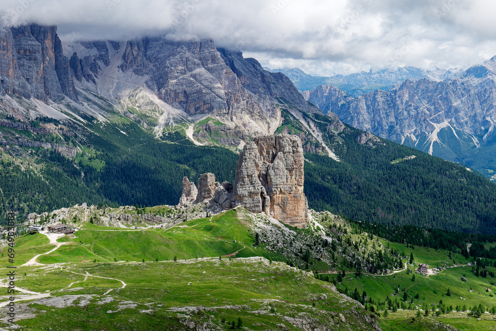 View of Cinque Torri with the Tofane mountain in the background covered with clouds. Famous climbing and alpinist place in the Dolomites, Italy. Travel destinations.