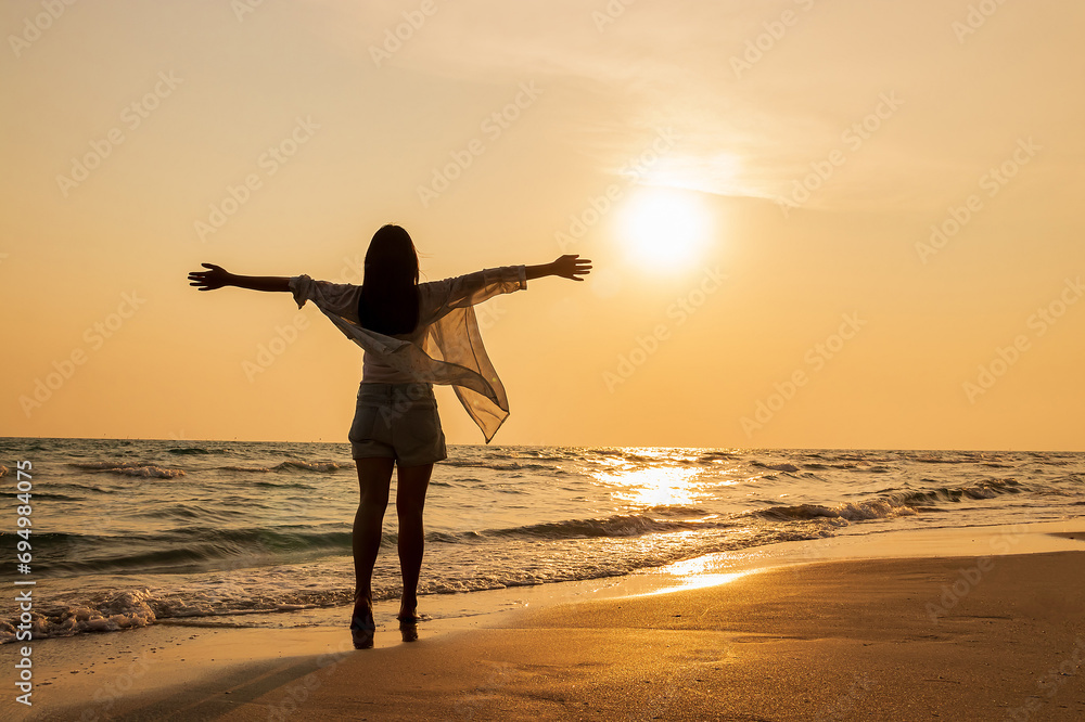 Fototapeta premium Beautiful young asian woman relax smile leisure around beach sea and enjoying sunset on the beach in Thailand.