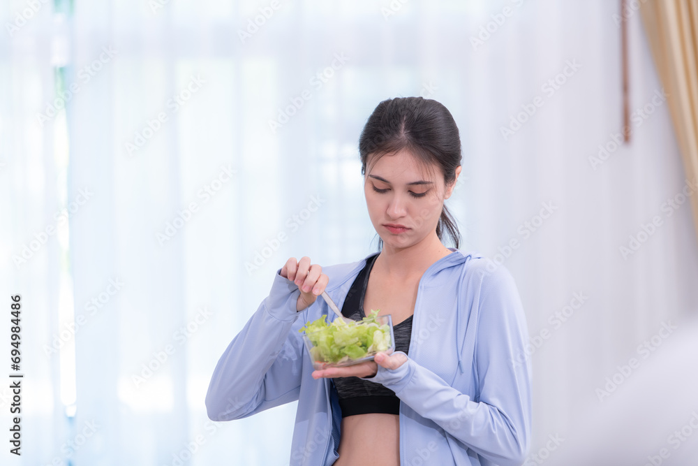 Beautiful asian woman eating salad in the morning at home. Beautiful asian woman eating salad in the morning at home.