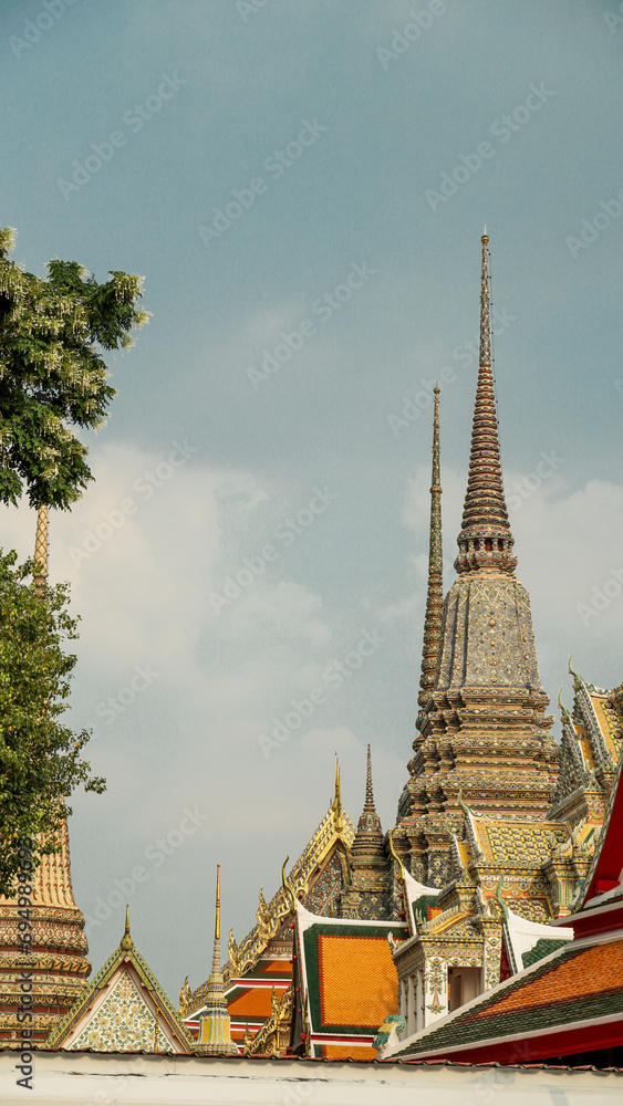 Fototapeta premium Traditional Thai style art of Thai temple, Thailand. Thai style art on the roof in temple. temple roof with against blue sky.