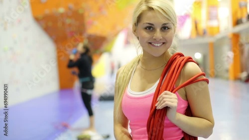 Portrait of smiling girl with red rope in climbing gym center photo