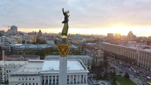 Kyiv Ukraine. Beautiful morning sun in central square of Kyiv Kiev Ukraine Maidan Nezalezhnosti Independence Monument. Golden beautiful Ukrainian woman statue. Aerial drone top viev. photo
