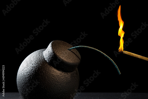 Картината върху платно A matching lighting fuse of an old vintage round cast iron fragmentation bomb ag