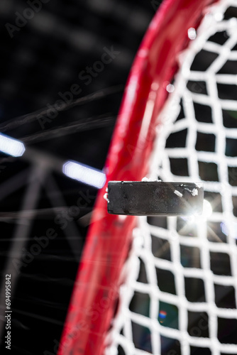 Photography An ice hockey puck flying mid-air as it as it scores a goal