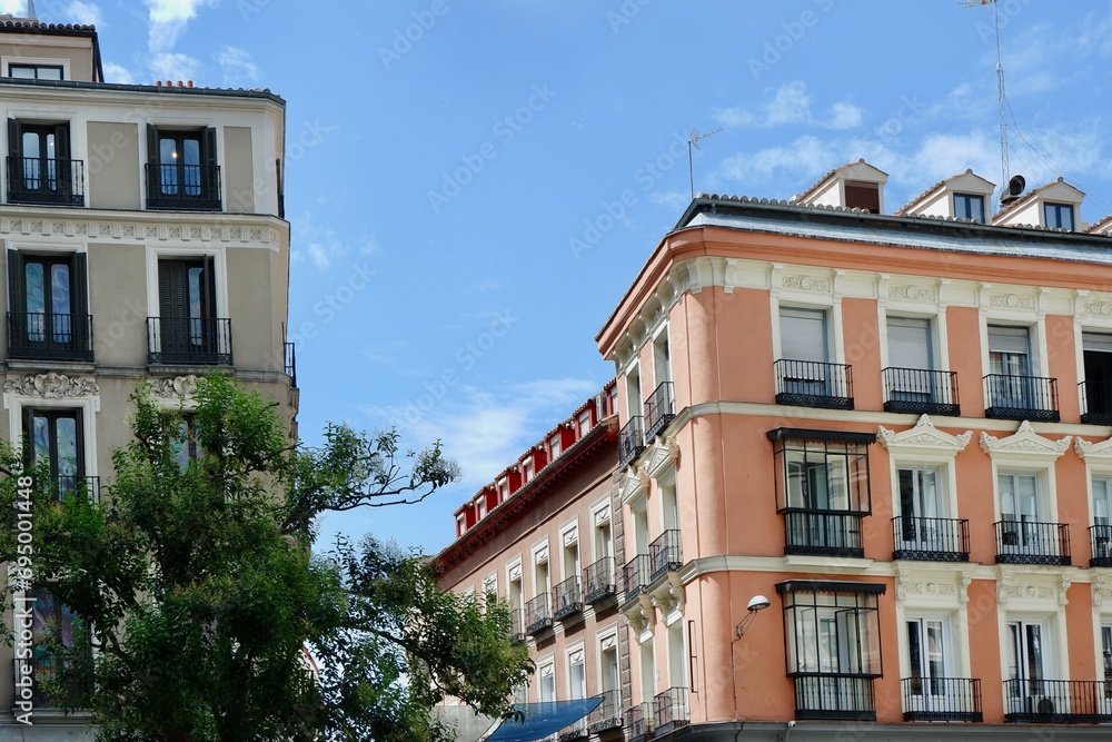 Classical buildings of pastel colours in the center of Madrid, Spain