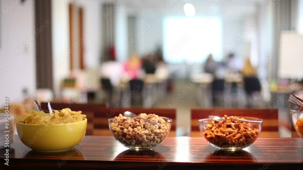 Many plates with different dry snacks on table in room Many plates with different dry snacks on table in room